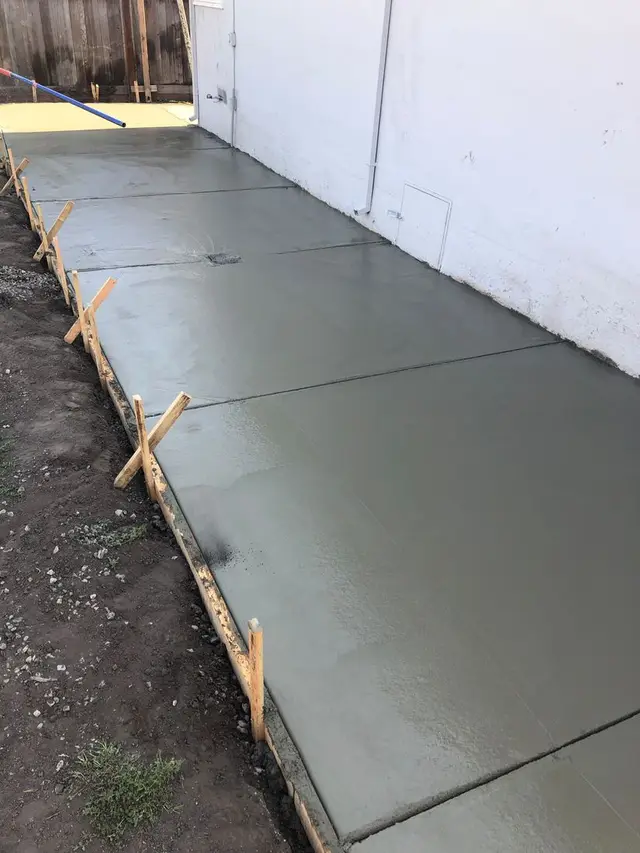 Finished concrete slab with clean edges and a cut control joint.